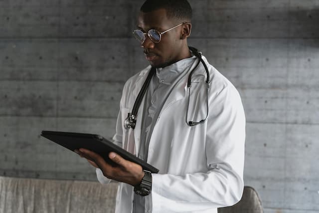 Doctor reviewing patient data on tablet